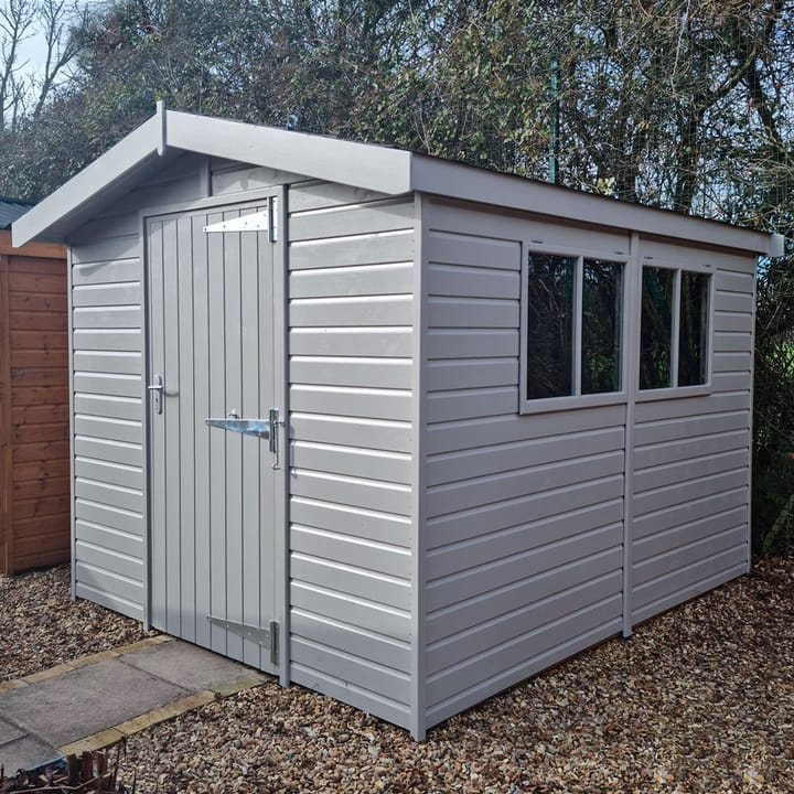 This 8ft x 10ft Heavy Duty Apex is constructed in heavy duty redwood cladding. A roof overhang and opening windows(s) are standard features. Ironmongery is available in a choice of black or as pictured here chrome. Optional felt tiles, double doors and a painted finish in urban grey have all been added.