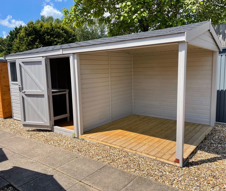 This 10ft x 8ft Heavy Duty Pavilion Apex is constructed in Heavy Duty Redwood cladding. A choice of door & window furniture is available in either black, or as pictured here chrome.

There are a number of optional upgrades pictured including; 'Fleet Grey' painted finish, felt tile roof and a workbench.

An optional 8ft wide Open area extension has also been added. A perfect sheltered area, large enough to fit a table and chairs or rattan furniture.