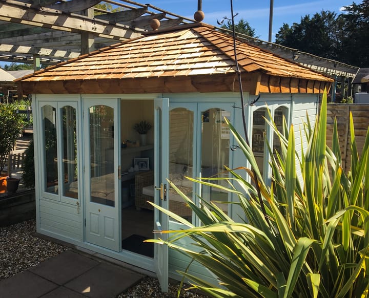 This 10ft x 8ft Malvern Ashton summerhouse is painted in Fern Green colour. The building has also had laminate flooring added.