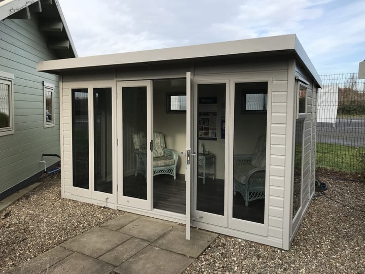 This 12ft x 8ft Studio Pent is painted in optional Fleet Grey colour. Optional tinted glass, painted mdf lining and insulation,  laminate flooring and privacy vent windows have also been selected 