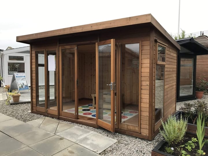 This 12ft x 8ft Studio Pent is constructed in Cedar cladding, one of 5 cladding options. Other cladding choices include redwood, pressure treated redwood, heavy duty redwood and heavy duty pressure treated redwood. 
Also pictured here is the optional tongue and groove lining and laminate floor