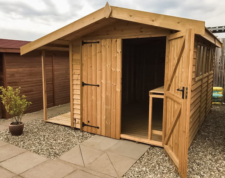 This 8ft x 12ft Heavy Duty Apex shed is constructed in Heavy Duty Barnstyle cladding. The shed has a number of optional upgrades including; a pressure treated slatted roof, double doors, a workbench to length and a 3ft logstore to the left hand side of the shed.