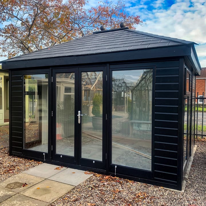 12ft x 10ft Malvern Studio Hipped painted in Black optional painted finish, with optional painted mdf lining and insulation, a deluxe laminate floor and slate effect tiled roof.