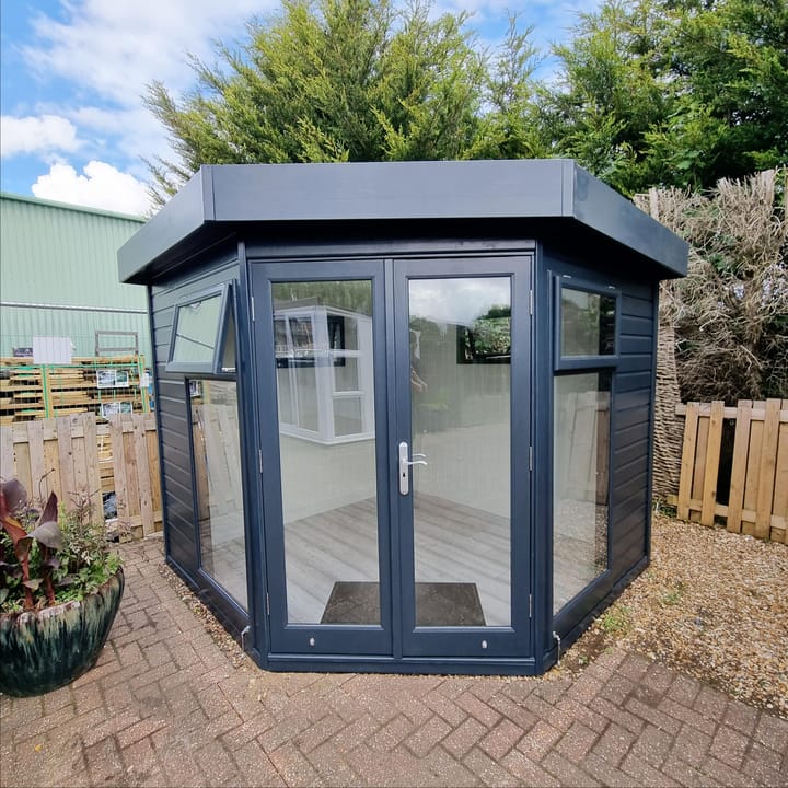 8ft x 8ft Studio Corner Flat in Squid ink painted finish, internal painted MDF lining and insulation, Laminate flooring and 2 x privacy vent windows.