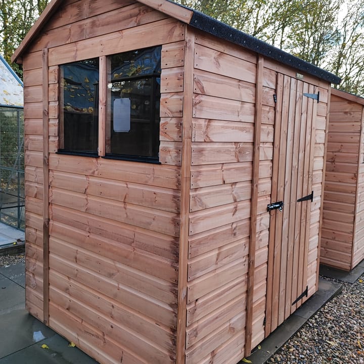 The Shedfast Apex shed is available in a range of sizes to suit all. 
Pictured here is the 5ft x 6ft model. The interchangeable windows and doors mean they can be positioned in any combination to suit your needs. The door is positioned in the side of this shed, but can easily be fitted to the gable end.

Black roofing felt is supplied as standard and the double pane windows are toughened safety glass with a pvc bottom cill.