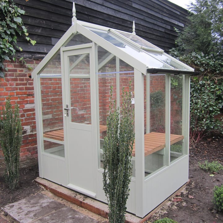 This 6ft x 4ft Swallow Kingfisher greenhouse has the optional 'Purbeck Stone' painted finish. Optional extra staging and guttering have been added to this greenhouse.