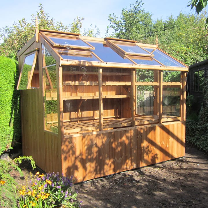 This 6ft x 8ft Swallow Jay greenhouse has the unpainted Thermowood finish. Optional additional high level shelving has been added to this greenhouse.