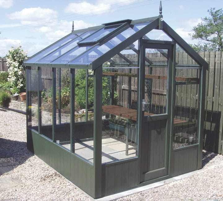 This 6ft x 8ft Swallow Kingfisher greenhouse has the optional 'Olive Green' painted finish. Optional high level shelving has been added to this greenhouse.
