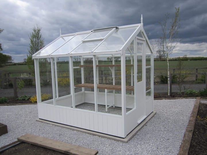 This 6ft x 8ft Swallow Kingfisher greenhouse has the optional 'Lily White' painted finish. Optional high level shelving has been added to this greenhouse.