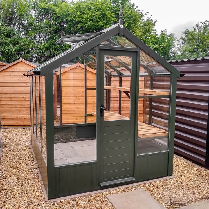 This 6ft x 8ft Swallow Kingfisher greenhouse has the optional 'Olive Green' painted finish.

Optional high level shelving and guttering have been added to this greenhouse.