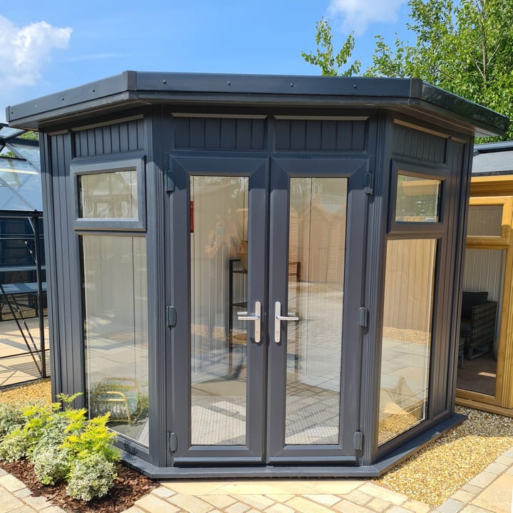 This Nordic Ramsey Corner is the 2.4m x 2.4m model in optional Grey finish with a flat roof. Other optional upgrades for this building as shown are the tile effect roof and vinyl flooring.
