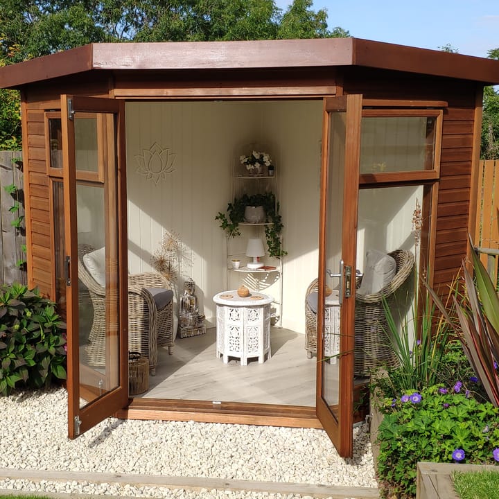 This 7ft x 7ft Studio Corner Pent looks stunning in this customers' garden. Cladded in cedar, this building has the optional painted mdf lining and insulation and laminate flooring.