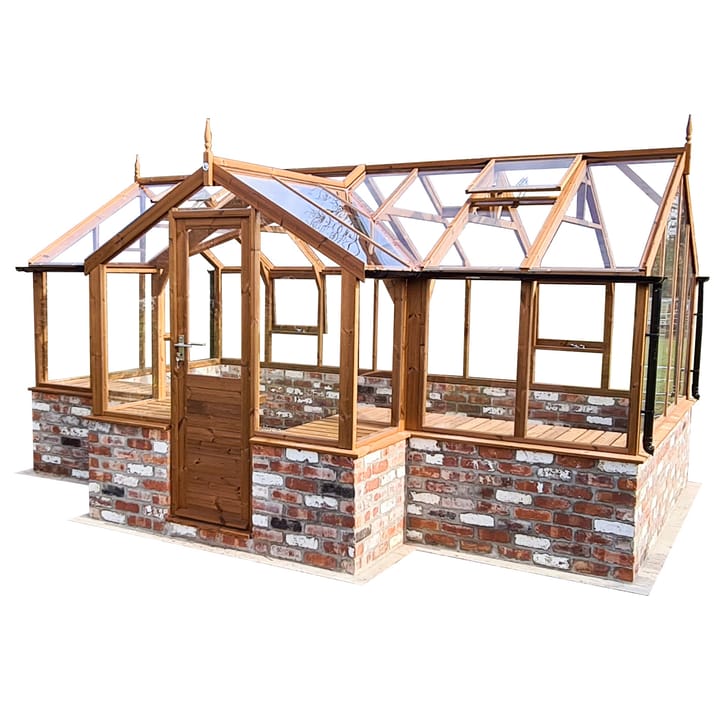 8ft 9in deep x 15ft 10in wide Swallow Mallard t-shaped greenhouse. The Mallard incudes front returned staging which sits at the front of the greenhouse and wraps around into the porch area. Optional 'Oiled finish' has been applied to the Thermowood timber.  The Mallard can be constructed either freestanding or as pictured here onto a dwarf wall. There is no extra cost for the dwarf wall option.