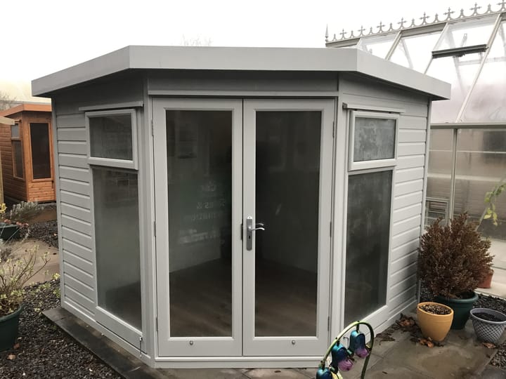 Redwood cladding has been used for this 8ft x 8ft Studio Corner Pent, which has also had the 'Dove Grey' optional painted finish. Optional laminate flooring and painted mdf lining & insulation are other additions to this building.