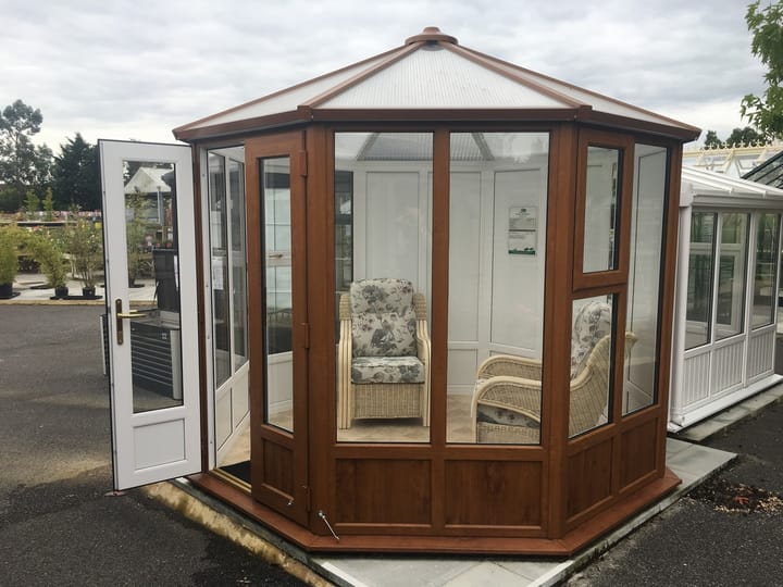 This 8ft 8in x 8ft 8in Sylt Pavilion is finished in Optional Golden Oak PVCu. Optional extras in the building as shown include; 3 x plain PVCu panels and vinyl flooring.