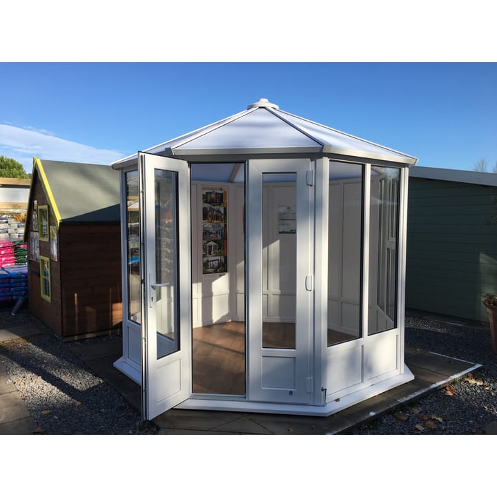 This 8ft 8in x 8ft 8in Sylt Pavilion is finished in white PVCu as standard. Optional extras in the building as shown include; a roof finial, 3 x plain PVCu panels and vinyl flooring.