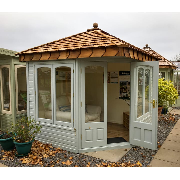 This 8ft x 8ft Clifton in Dove Grey looks absolutely stunning. The 'cottage' style arched windows really add a decorative touch. Brass has been chosen for the door and window furniture. 

One point worth knowing: If you opt for the double glazing upgrade, the arched top of the windows become square to accommodate the double glazed units.