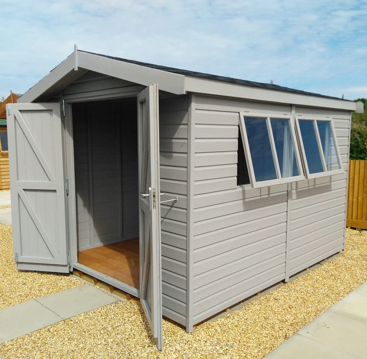This 8ft x 10ft Heavy Duty Apex is constructed in heavy duty redwood cladding. A roof overhang and opening windows(s) are standard features. Ironmongery is available in a choice of black or as pictured here chrome. Optional felt tiles, double doors and a painted finish in fleet grey have all been added.