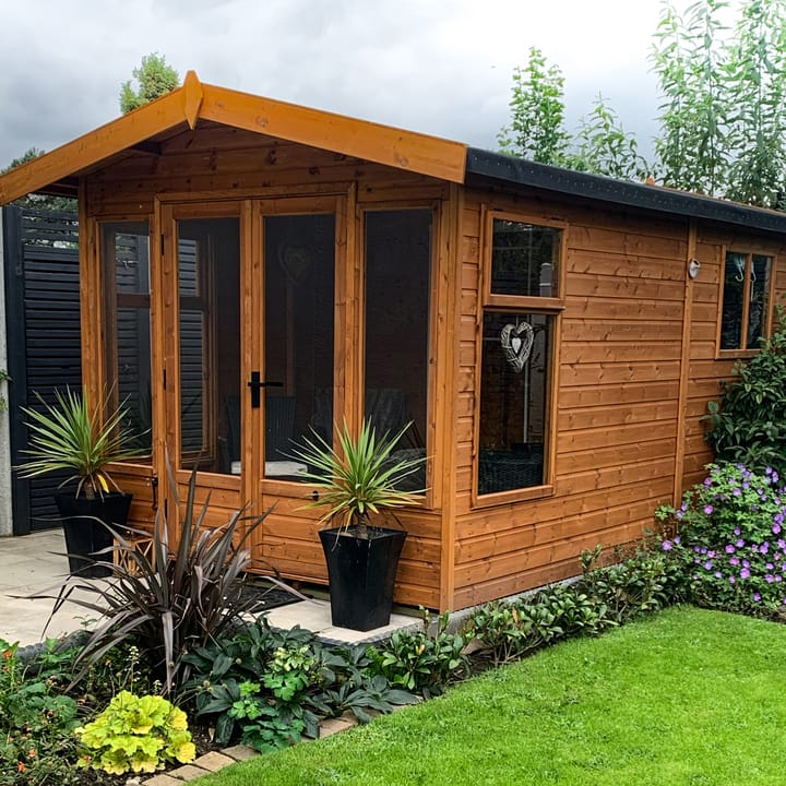 This 8ft x 8ft Tenbury is tucked away neatly in this customer's garden. Constructed in Redwood cladding, this Newland has a black felt roof and an optional 6ft deep shed extension with an external shed door and shed window.
