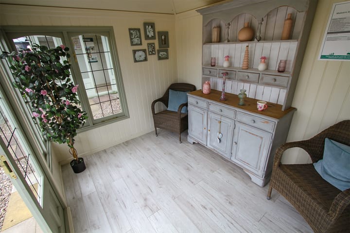 When your Harwood summerhouse is installed, styling it is the fun bit! Here a pine cottage dresser, some rattan furniture, photo frames and an artificial plant make this Malvern Ashton look super cosy!
