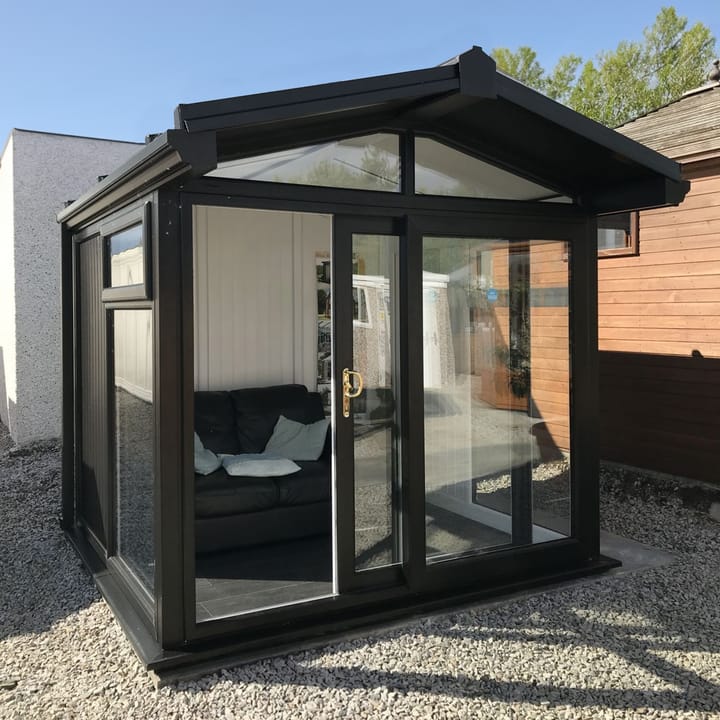 This Nordic Aspen Apex is the 2.4m x 2.2m model in optional Black finish. The vinyl flooring in this building is an optional upgrade.

The Aspen Apex features a large sliding door to the front with full length windows on each end, positioned to the front of the building. Each window also includes an opening vent.