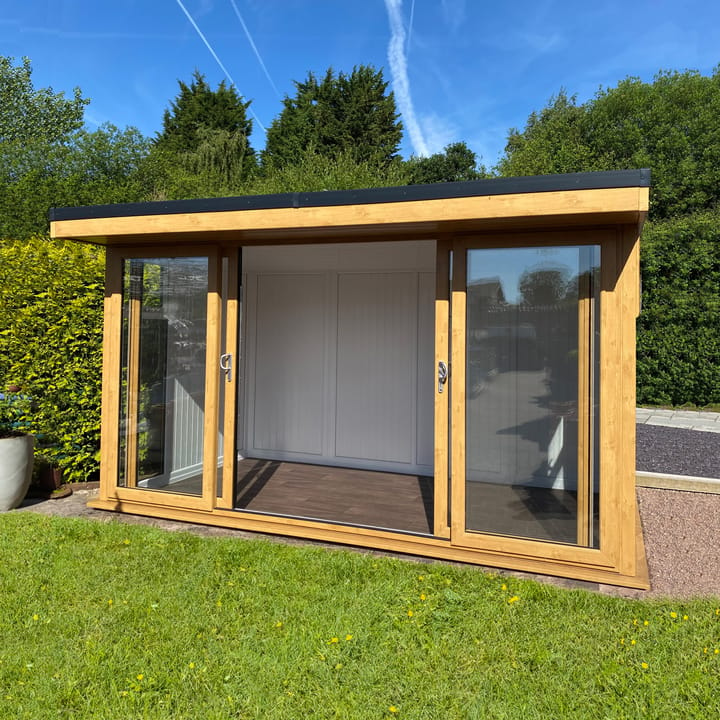 Nordic Broadway Flat 4.2m x 2.4m in Irish Oak. The Broadway Flat includes large double sliding doors to the front. A glass to ground window with a top opening vent is positioned in each end, towards the front. The fully glazed front of the building allows plenty of natural light without obscuring the view.