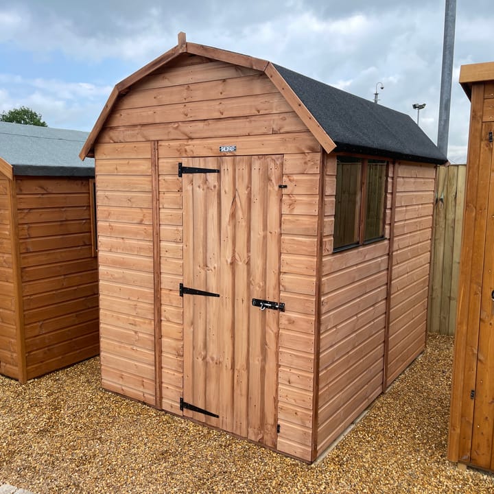 The Shedfast Dutch Barn shed is available in a range of sizes to suit all. 
Pictured here is the 6ft x 8ft model. The interchangeable windows and doors mean they can be positioned in any combination to suit your needs. The door is positioned in the gable end of this shed, but can easily be fitted on the side.

Black roofing felt is supplied as standard and the double pane windows are toughened safety glass with a pvc bottom cill.