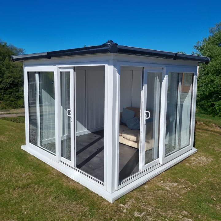 This Nordic Madison Corner Hipped is the 2.7m x 2.7m model in optional White finish. Other optional upgrades for this building as shown are the tile effect roof and vinyl flooring.