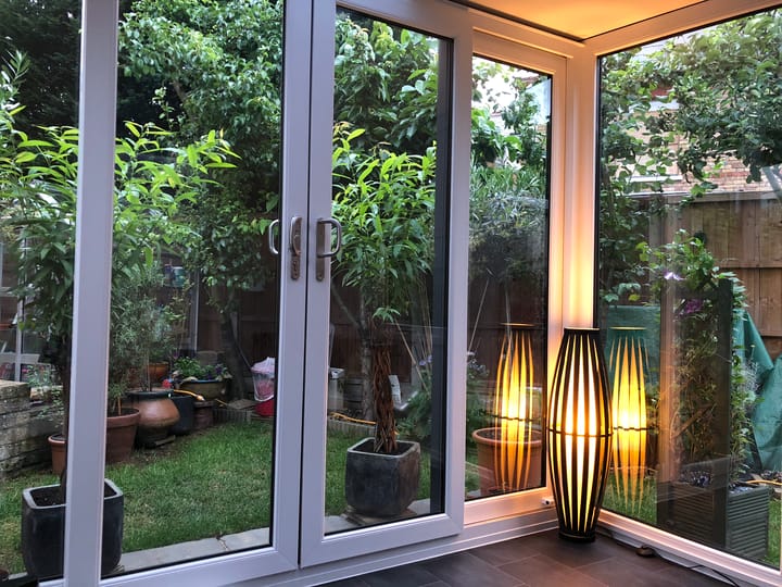 This interior shot from a Nordic Greenwich Pavilion garden room, shows how the combination of full length glazing, the optional vinyl flooring and gentle lighting creates a unique and uplifting mood in this room.