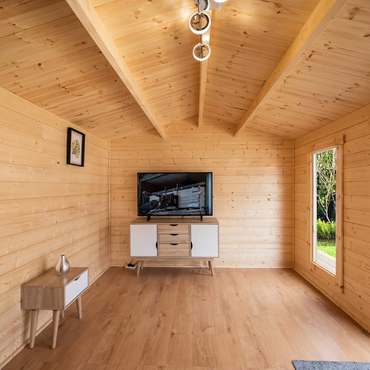 This interior photo of a 5m x 3m Pavilion gives a good idea of what you can expect from the interior of a log cabin. There's a warm and airy feeling to this cabin and the laminate flooring gives a nice light contrast to the natural timber finish. 