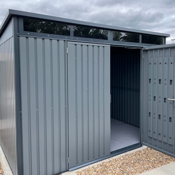 10 x 8 HEX Hixon shed in Anthracite Grey. The Hixon features double opening doors to the front. The doors include an integrated organisation panel, ideal for hanging garden tools. Transom windows run the width of the building above the doors, allowing light through. The Hixon is also available in Sage Green.