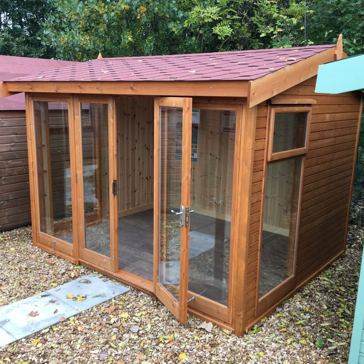 10ft x 8ft Malvern Studio Pavilion in standard Redwood cladding. Optional upgrades include a red felt tiled roof, tongue and groove lining and insulation and a deluxe laminate floor.