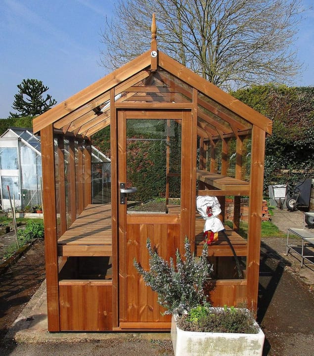 The popular 5ft8 wide Robin, from Swallow, is the ideal wooden greenhouse for the smaller garden. Shown here as an 8 ft long model, in plain finished Thermowood®