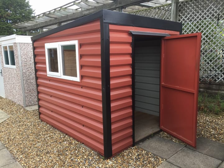 This Lifelong Pent is 8ft wide x 7ft deep and is finished in Terracotta colour. This building has had the optional extra of the door being moved to the side of the shed.