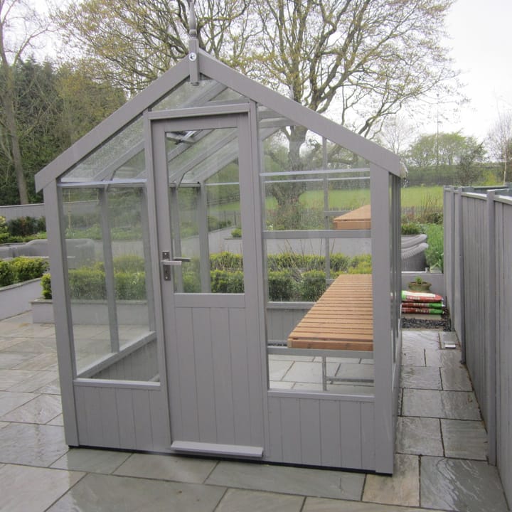 This 6ft x 8ft Swallow Kingfisher greenhouse has the optional 'Moles Breath' painted finish. Optional high level shelving has been added to this greenhouse.