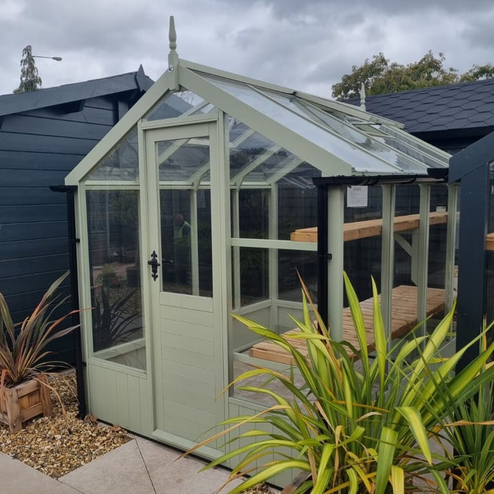 This 6ft x 8ft Swallow Kingfisher greenhouse has the optional 'Vert De Terre' painted finish.

Optional high level shelving and guttering have been added to this greenhouse.